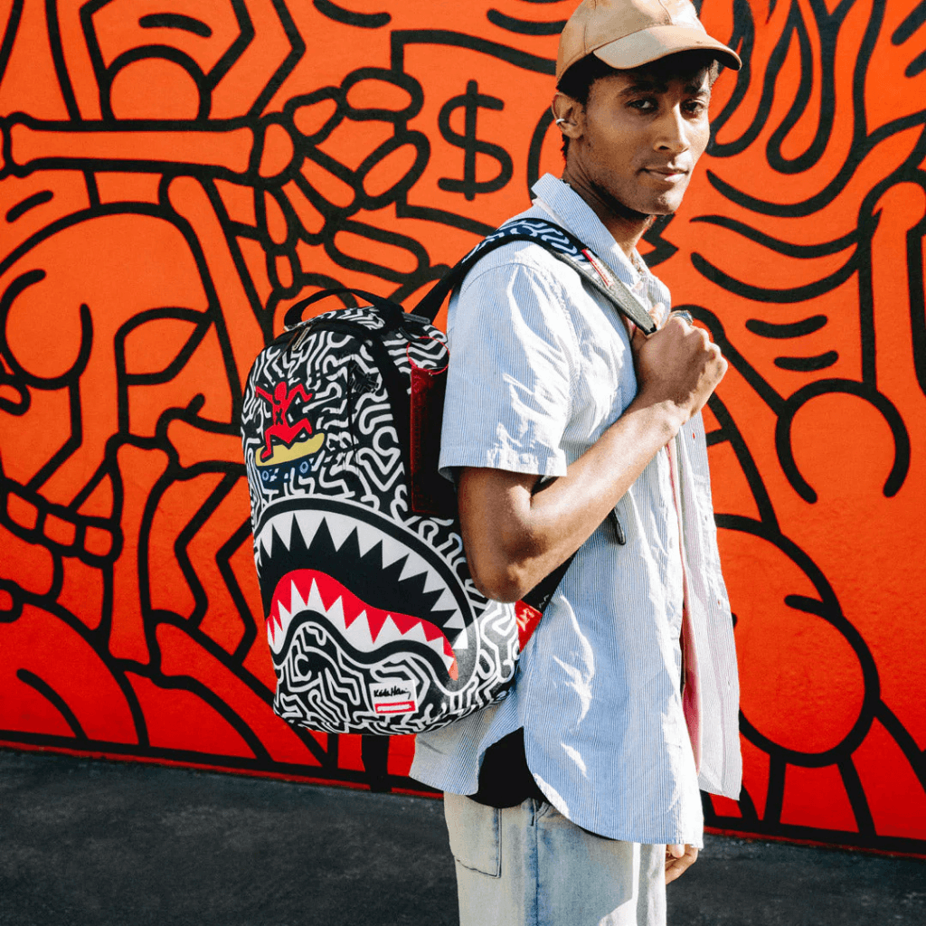 MORRAL SPRAYGROUND KEITH HARRING SKATER GUY PRINT DLXSV BACKPACK